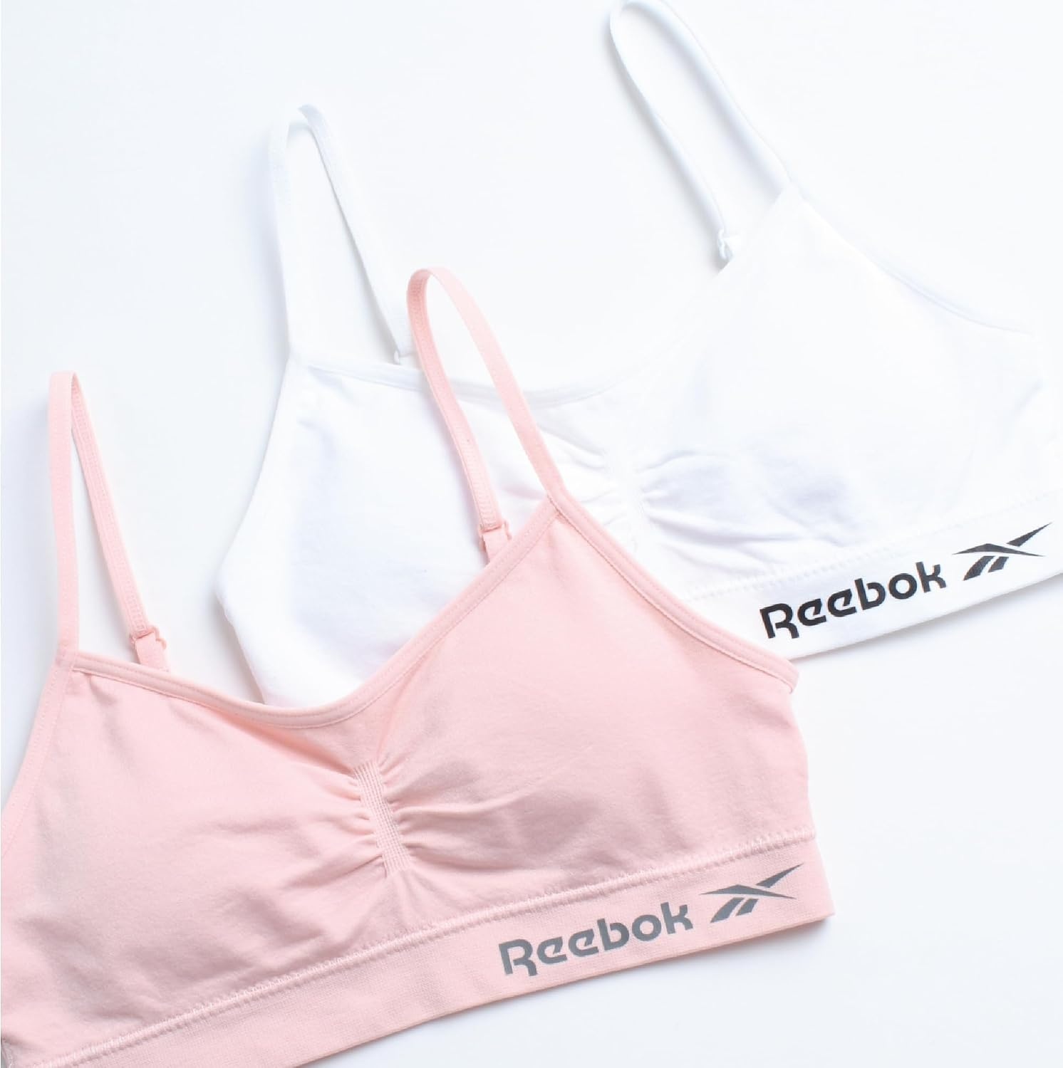 image:imageReebok Girls Training Bras 2 Pack Racerback Bralettes Removable Pads SuperSoft Fabric with a Sporty RacerStyle Back Fit Stays Comfortably in Place Through Dance Gym and PlayPinkWhite