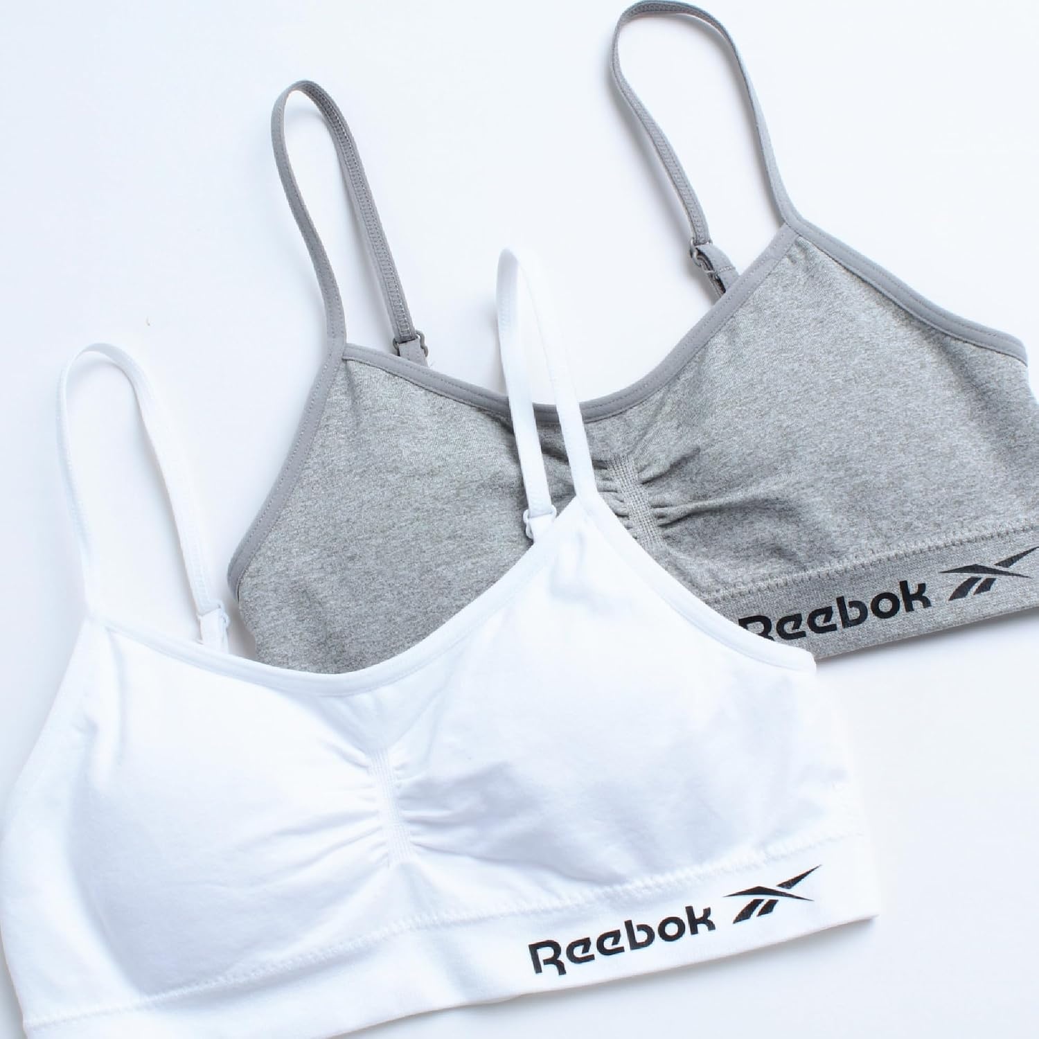 image:imageReebok Girls Training Bras 2 Pack Racerback Bralettes Removable Pads SuperSoft Fabric with a Sporty RacerStyle Back Fit Stays Comfortably in Place Through Dance Gym and PlayGreyWhite
