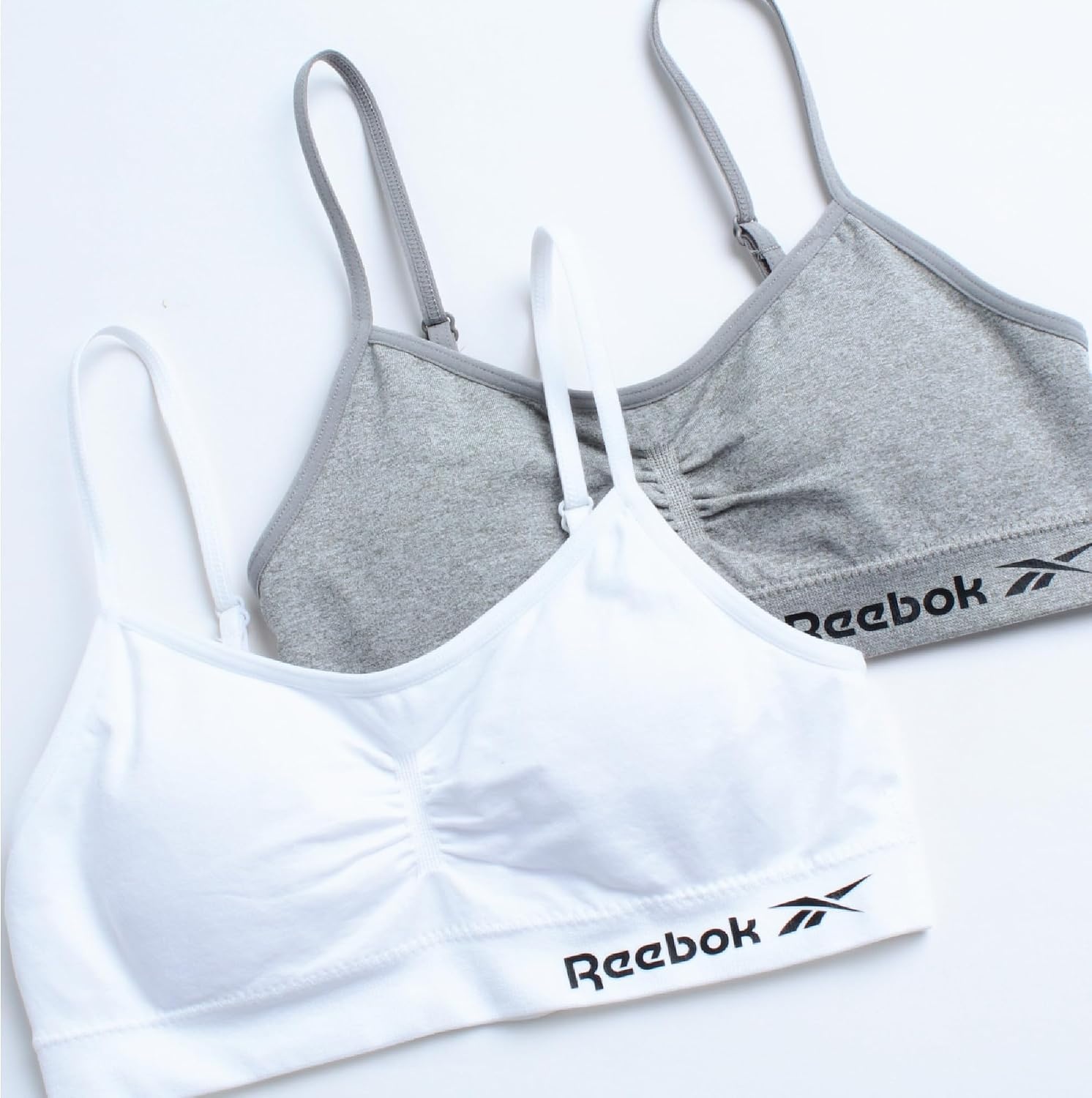 image:imageReebok Girls Training Bras 4 Pack Racerback Bralettes Removable Pads SuperSoft Fabric with a Sporty RacerStyle Back Fit Stays Comfortably in Place Through Dance Gym and PlayGreyWhite