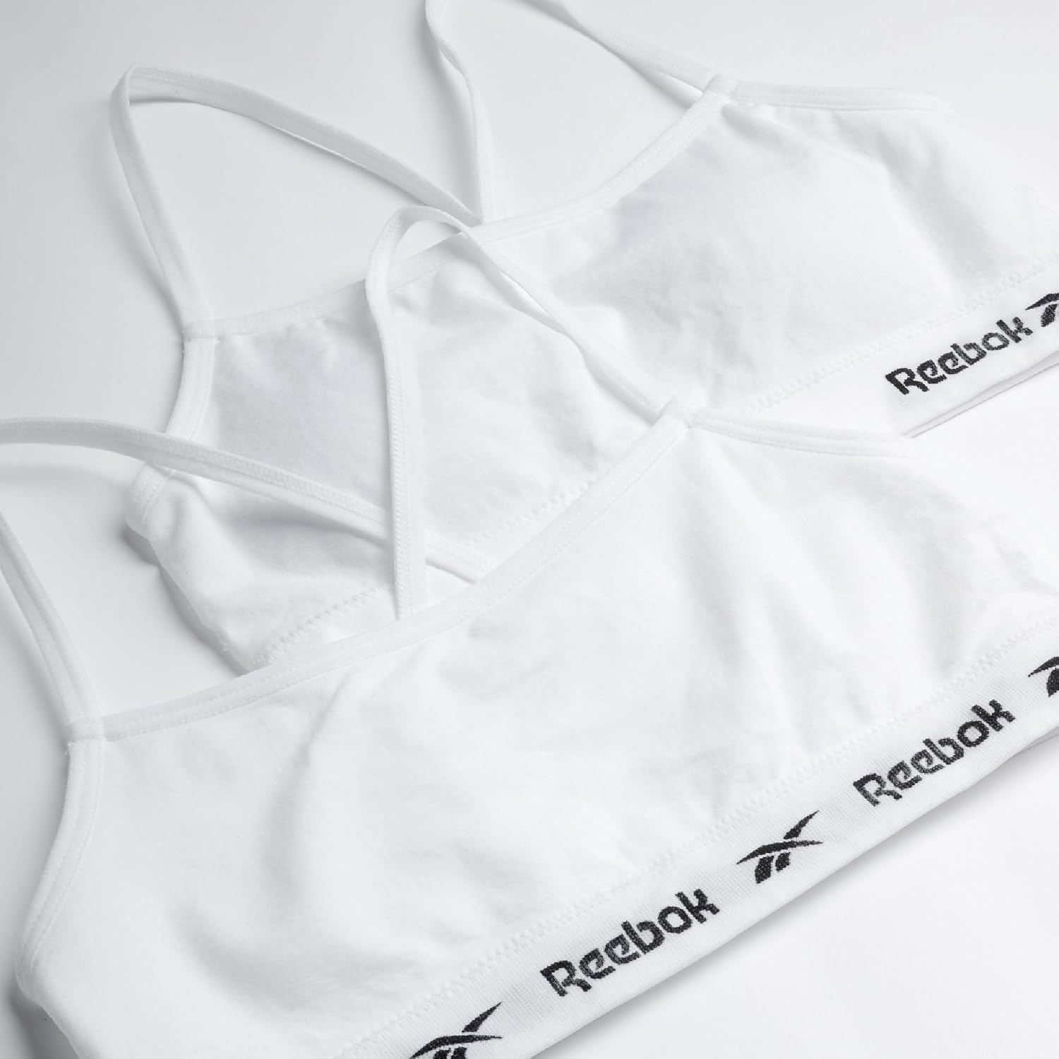 image:imageReebok Girls Training Bras 4 Pack Racerback Bralettes Removable Pads SuperSoft Fabric with a Sporty RacerStyle Back Fit Stays Comfortably in Place Through Dance Gym and PlayWhitePure White