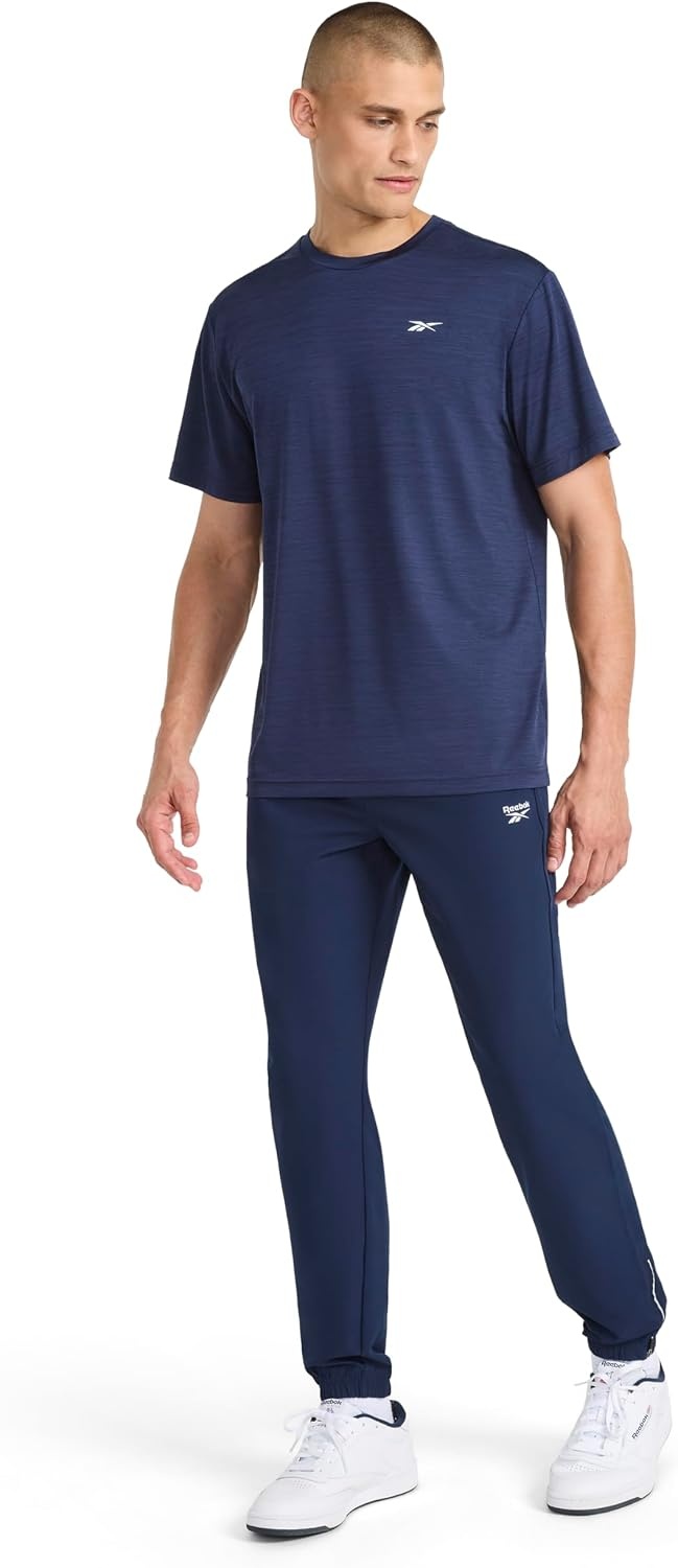 image:imageReebok Mens Reflective Small Logo Crewneck TShirt Standard Fit Lightweight Cool Touch Jersey FabricVector Navy Heather Lightning