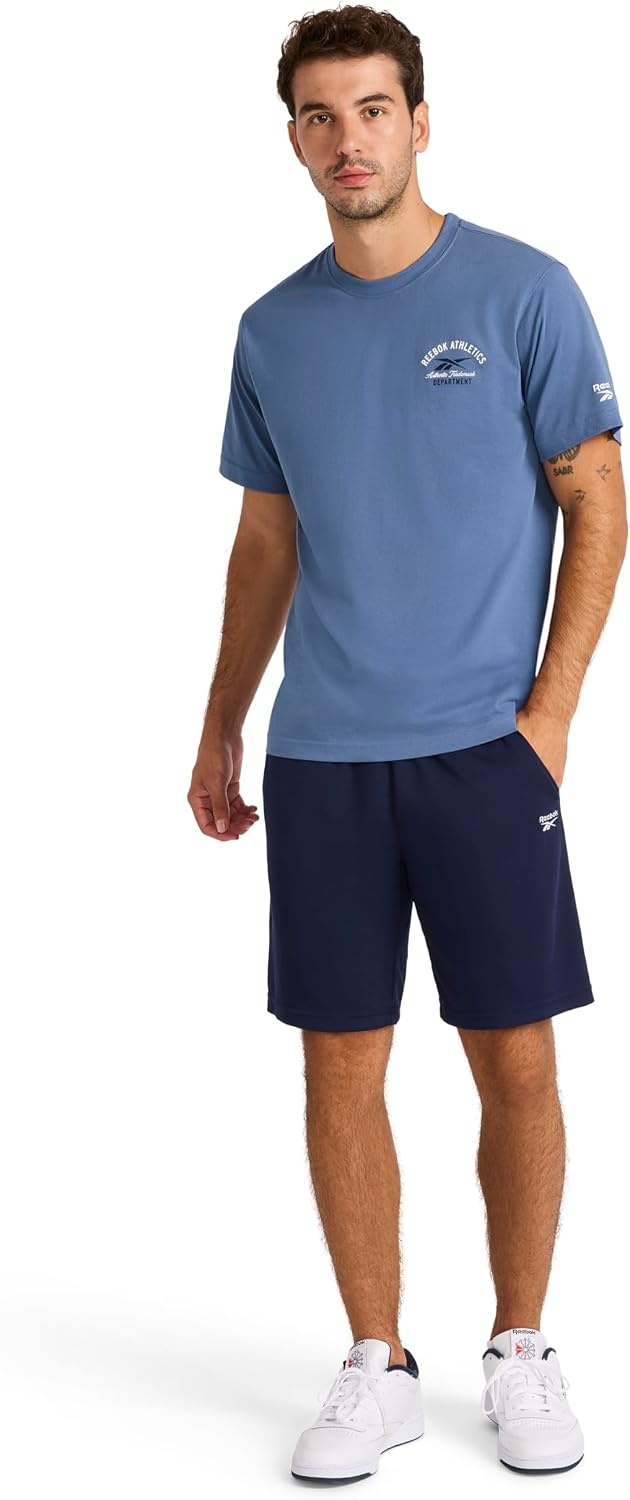 image:imageReebok Mens Small Logo Crewneck TShirt Standard Fit Lightweight CottonPoly Jersey FabricVector Shadow Athletics Dept